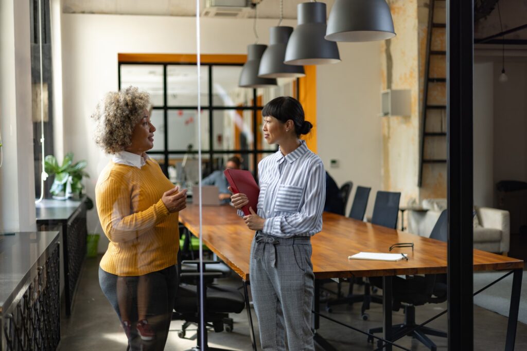 Two coworkers discussing an issue in a conference room